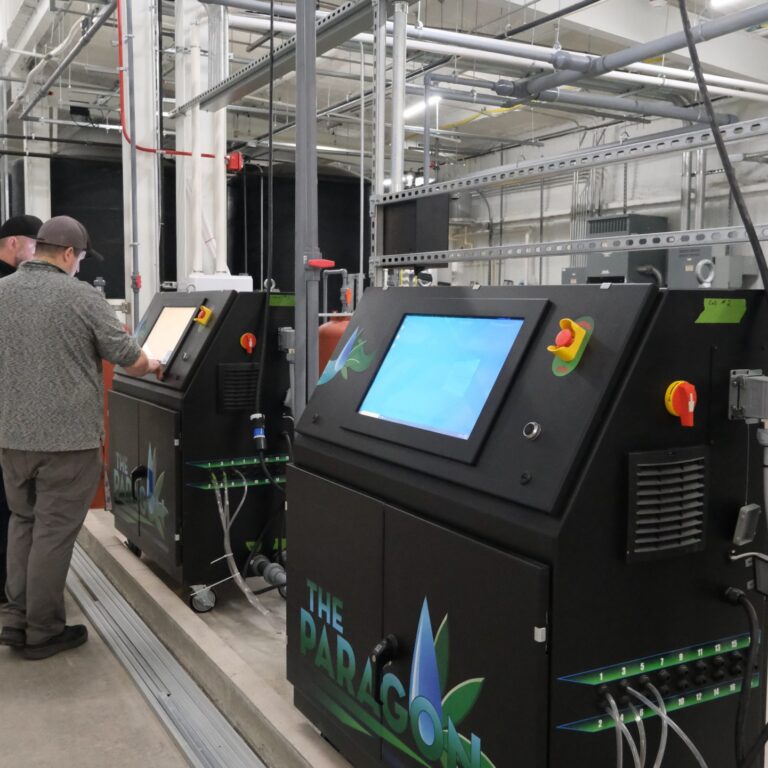 Operator using a row of Paragon fertigation machines in facility